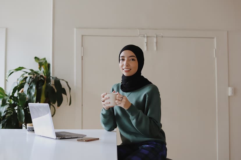 Professional woman working with laptop and coffee